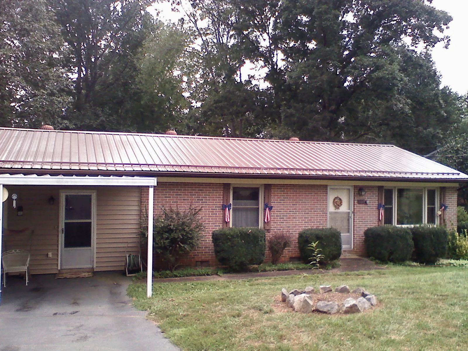 Bronze metal roof and carport on a brick ranch home — Roof Repair work by our crew in Los Molinos